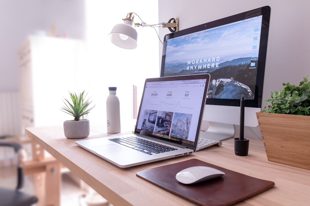 Modern remote workspace — laptop, monitor, and desk setup